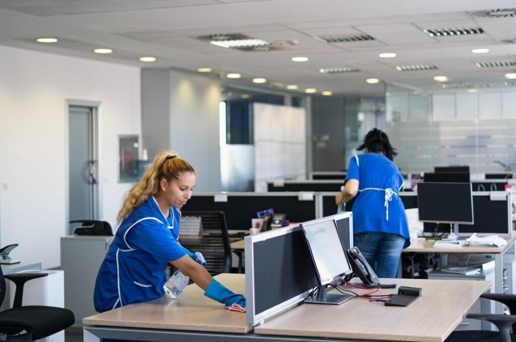 Cleaners clean empty office spaces